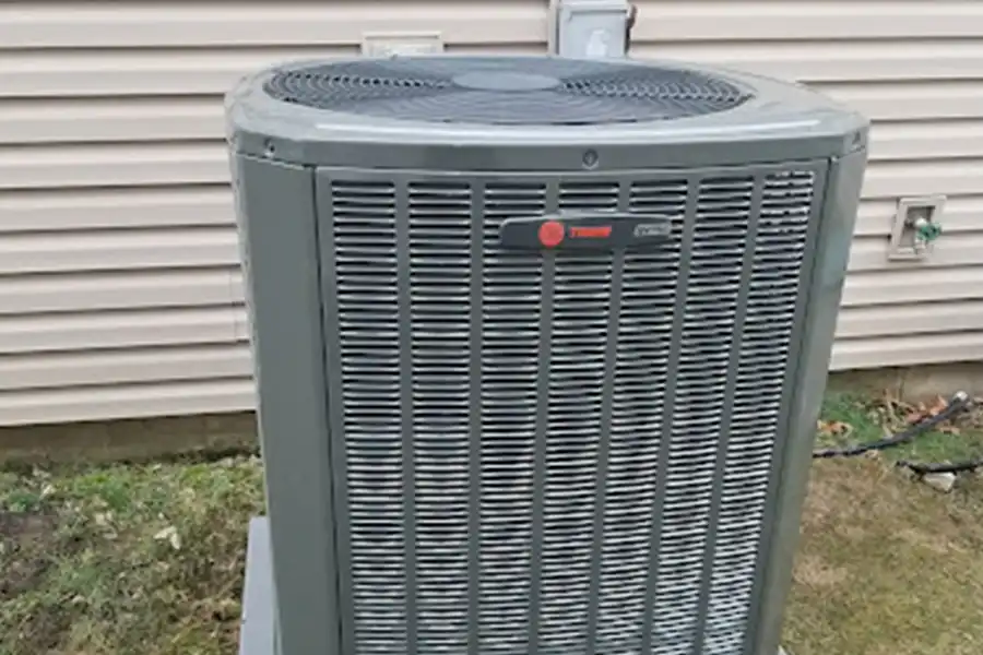 Modern heat pump installed to replace an older residential HVAC system
