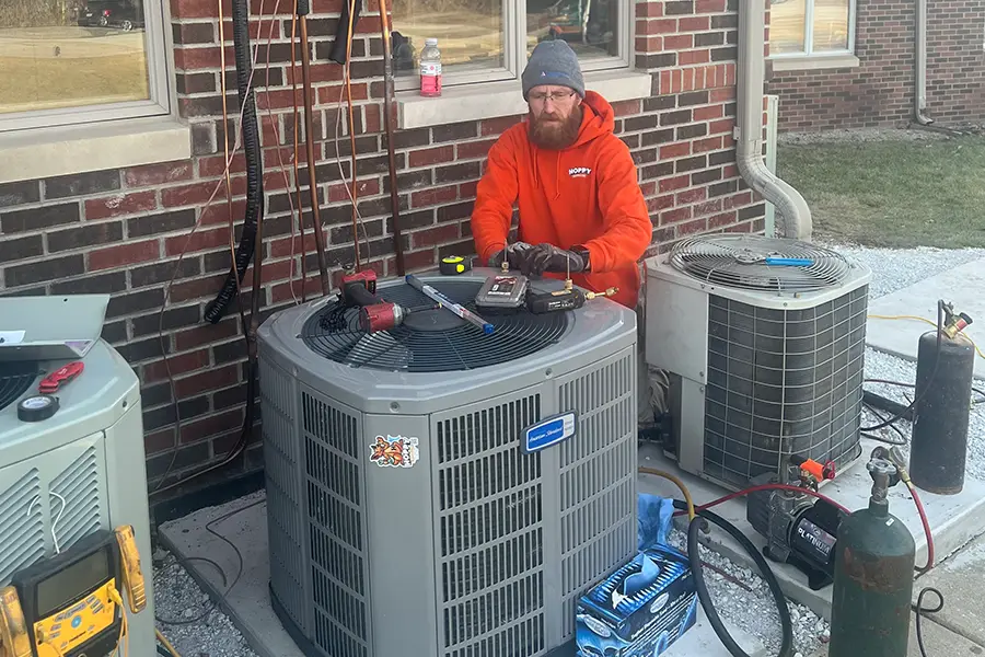 Outdoor AC condenser being installed and tested during a residential AC installation
