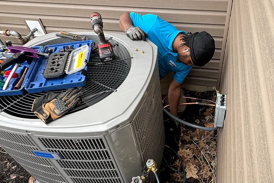 Residential AC system undergoing routine maintenance with professional HVAC tools