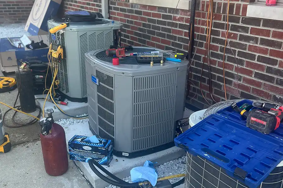 Multiple residential heat pumps undergoing professional repair and performance testing